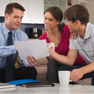 A financial planner in Winnipeg discussing investment strategies with a couple.